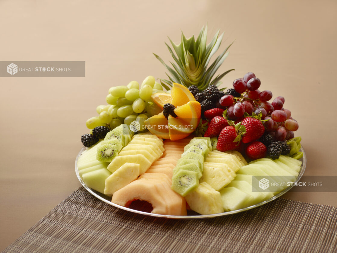 fresh fruit platter on a brown background