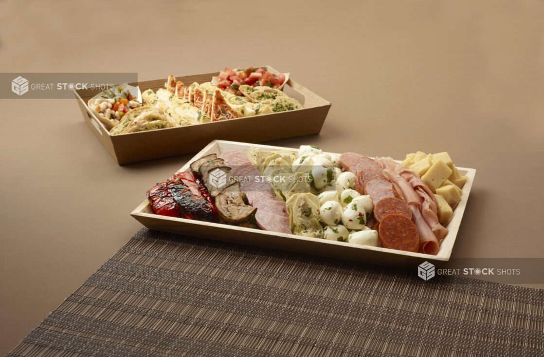 mixed antipasto platter with a side gourmet bread basket