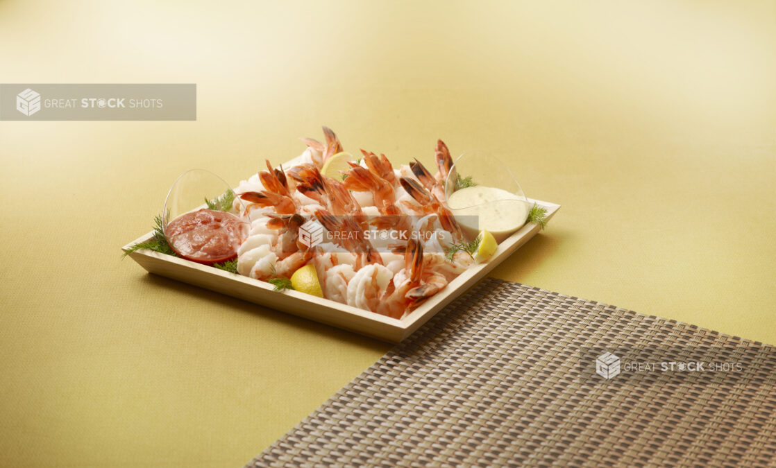 wood catering tray of cocktail shrimp with side of tartar and cocktail sauce