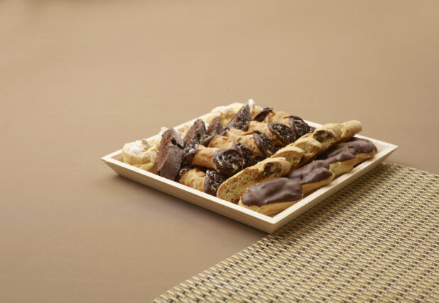 Dessert platter with eclairs biscotti chocolate cannoli chocolate biscotti italian wedding cookies