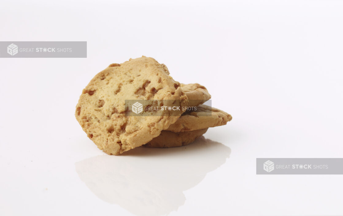 Chocolate chip cookies in a pile on white background