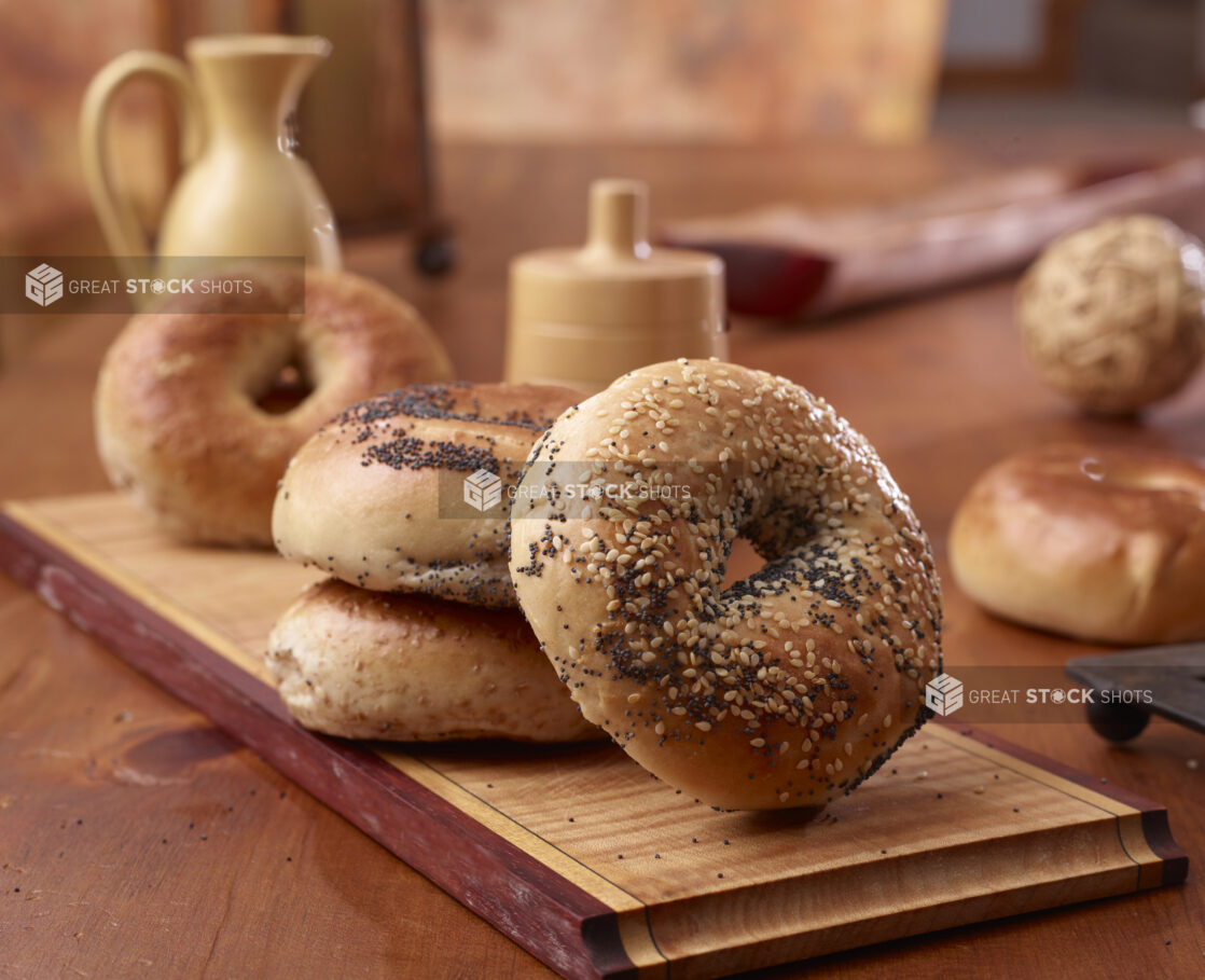 Close Up of Sesame and Poppy Seed Bagels on a Wood Board in an Indoor Kitchen Setting – Variation 2