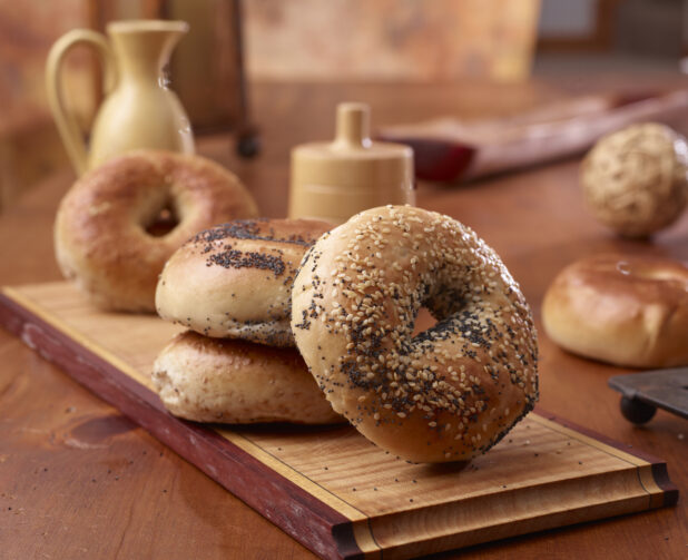 Close Up of Sesame and Poppy Seed Bagels on a Wood Board in an Indoor Kitchen Setting – Variation 2