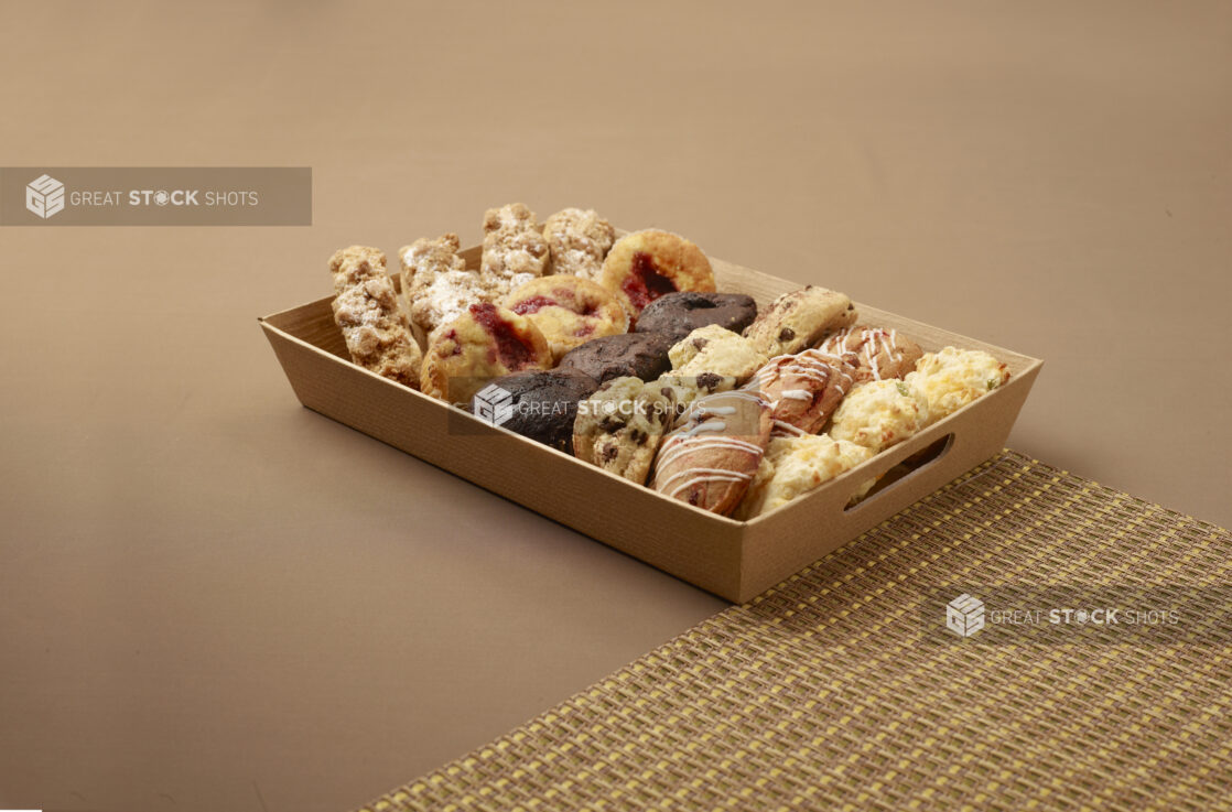 Tray of assorted baked goods for catering - muffins, scones, cookies, biscuits