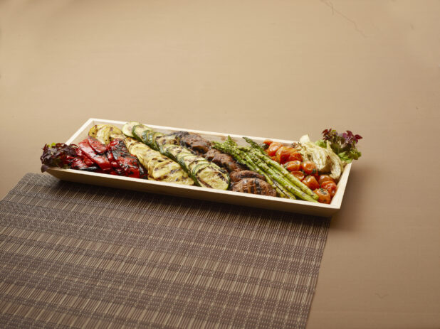 A Narrow Rectangular Wood Platter of Assorted Roasted and Grilled Vegetables for Catering  - Side Dish
