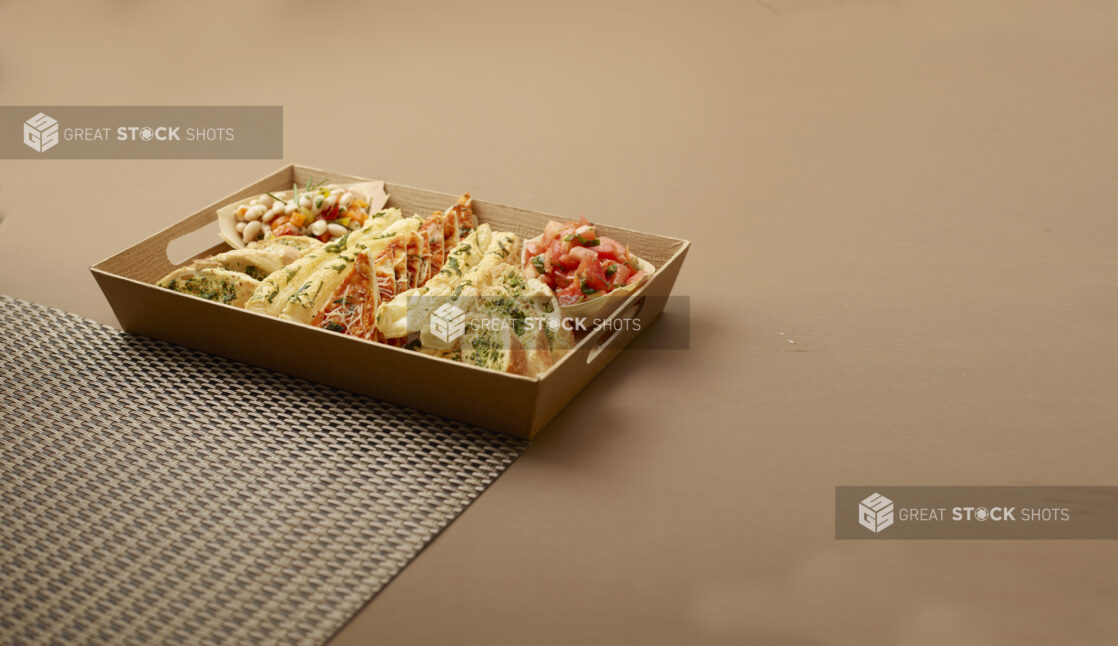 Platter of Assorted Breads, Flatbreads and Bread Sticks with Tomato and Bean Salsas in a Wooden Tray for Catering - variation