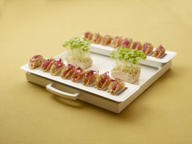 Mini Tuna Tartare Tacos on a White Catering Platter with Fresh Bean Spouts on a Yellow Surface
