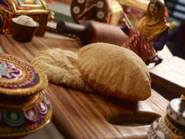Bhatura - Indian Deep Fried Sourdough Bread - on a Wooden Platter in an Indoor Setting