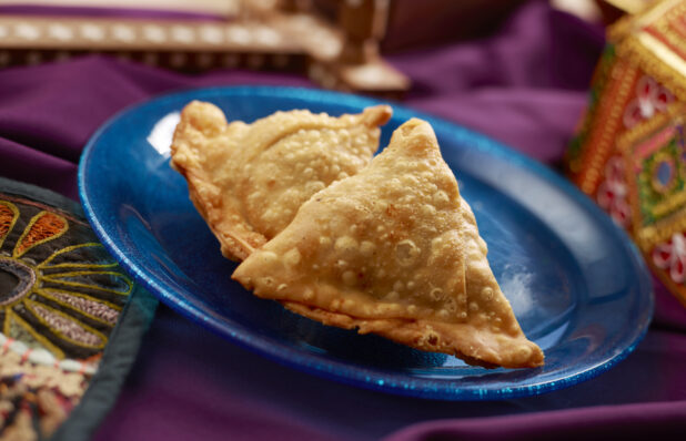 Indian Savoury Snack - Samosas - on a Blue Ceramic Plate on a Purple Tablecloth in an Indoor Setting