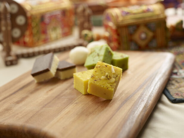 Assorted Sweet Indian Dessert Squares and Balls on a Wooden Platter in an Indoor Setting - Variation
