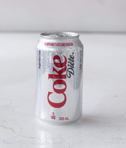 Close Up of a Can of Diet Coke on a White Surface in an Indoor Setting