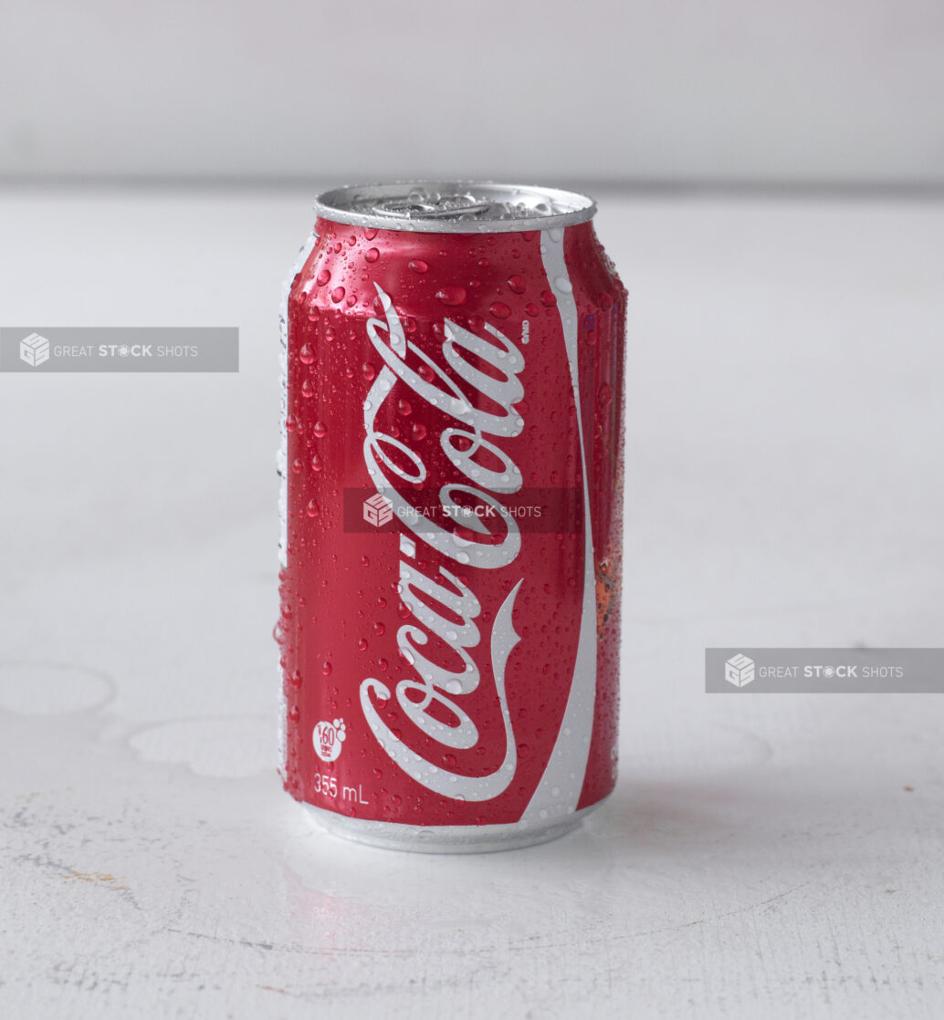 Close Up of a Can of Coca-Cola on a White Surface in an Indoor Setting