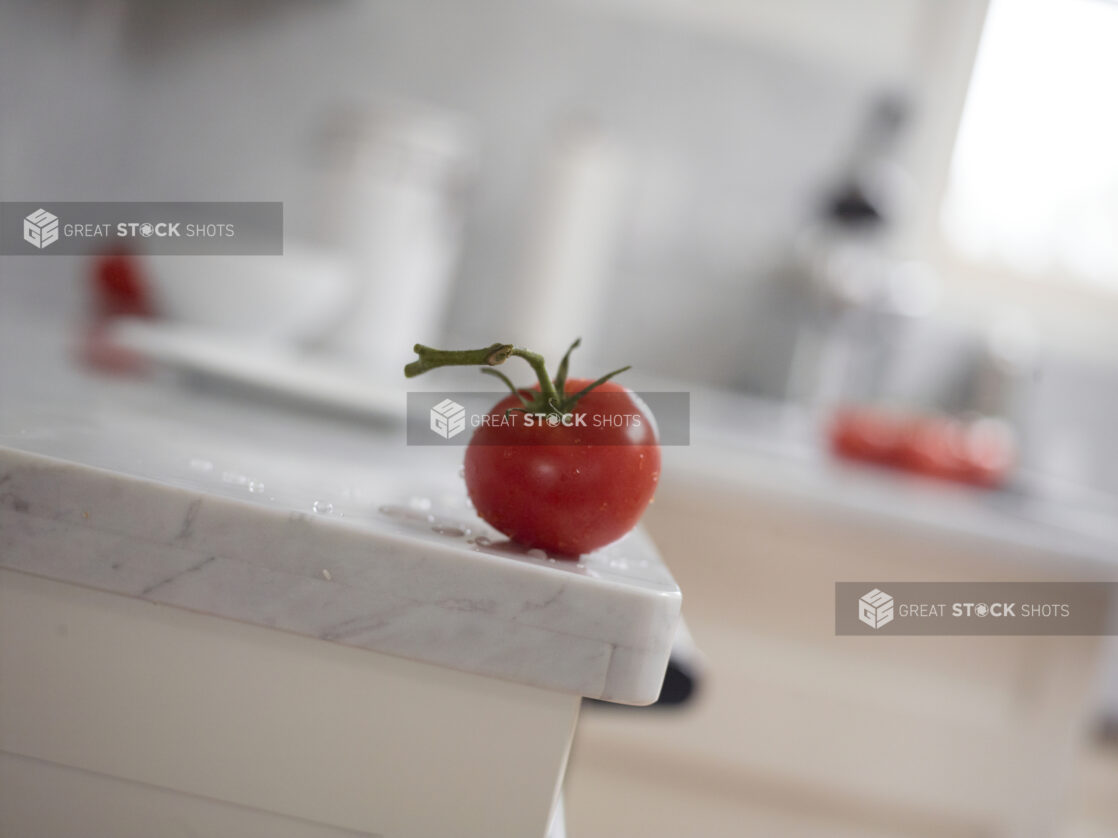 Tomato on Vine on Marble Counter with Bokeh Background