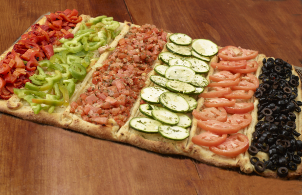 Flatbread Pizza with Assorted Fresh and Roasted Vegetable Toppings: Sliced Tomatoes, Black Olives, Bruchetta, Zucchini on a Wooden Table - Variation