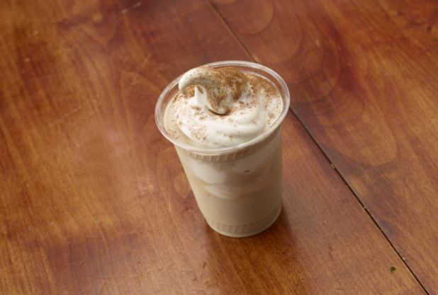 Frappuccino with Soft Serve Ice Cream in a Clear Plastic Take-Out Cup on a Wooden Surface