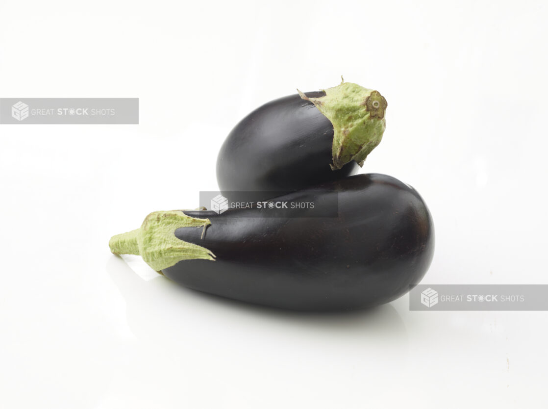 2 whole fresh eggplant on a white background