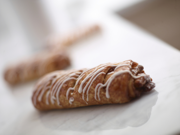 Chocolate croissant on a white marble tabletop, close-up