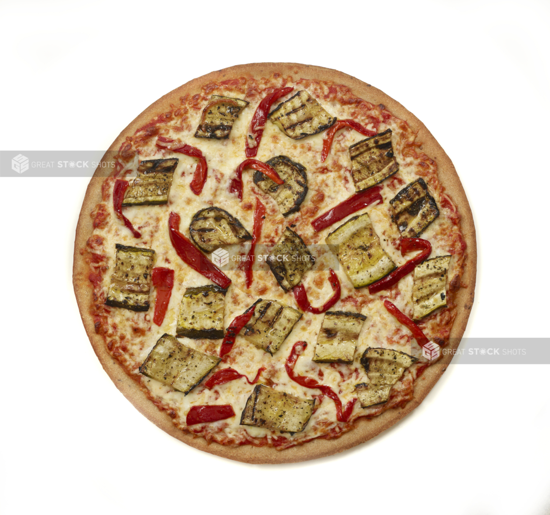 Whole unsliced grilled zucchini and roasted red pepper pizza isolated on a white background, overhead view