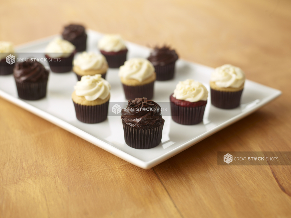 A Platter of Frosted Cupcakes for Catering on a Wooden Table