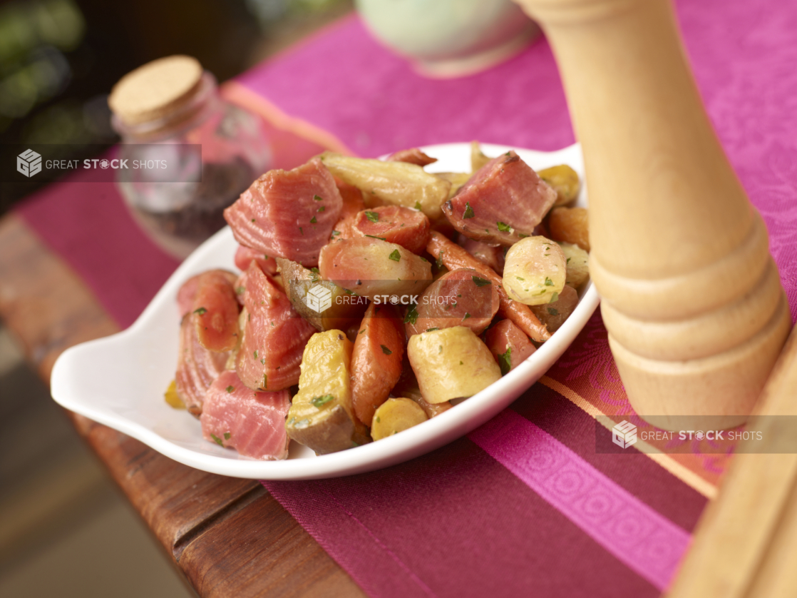 Warm Beets, Carrots and Potato Salad in a White Ceramic Dish on a Pink Tablecloth in an Outdoor Garden Setting - Variation