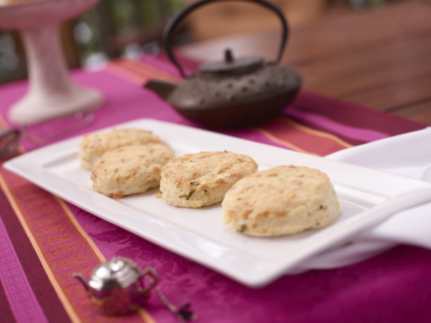 Scones in a White Ceramic Platter on a Pink and Red Table Cloth Surface