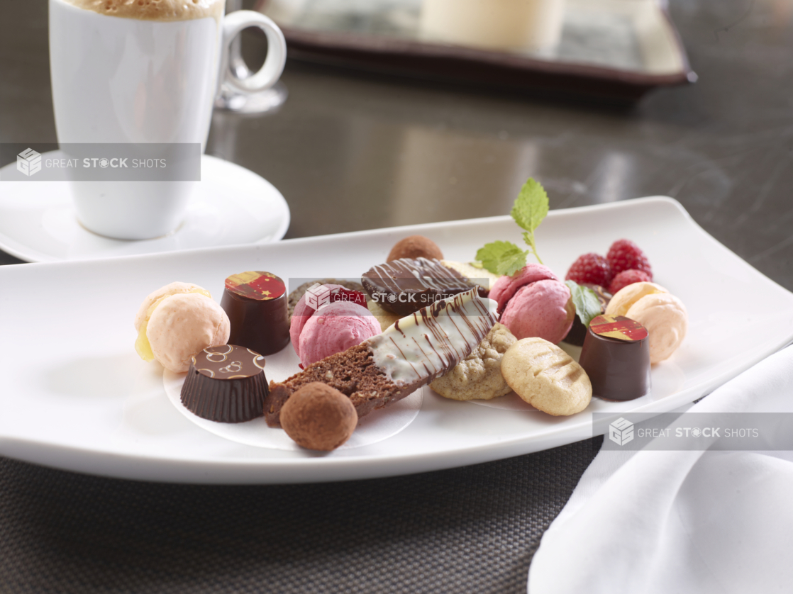 A Platter of Mini Desserts, Macaroons, Chocolates, Biscotti and Cookies in a Fine Dining Setting
