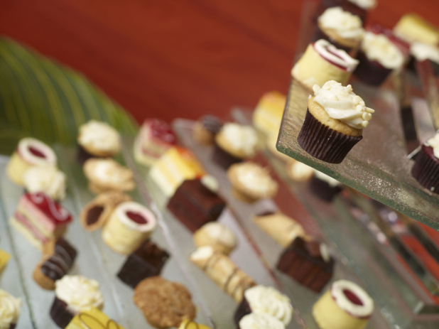 Miniatures Desserts, Cupcakes and Pastries Displayed on Glass Tiers in an Indoor Setting