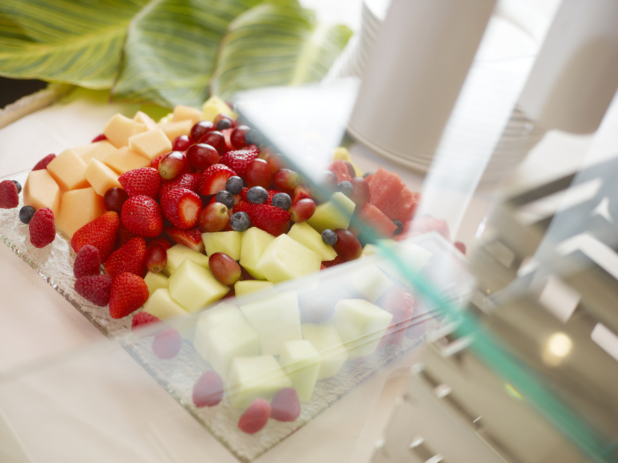 Fresh fruit platter with cubes of melon, whole strawberries, blueberries, and grapes