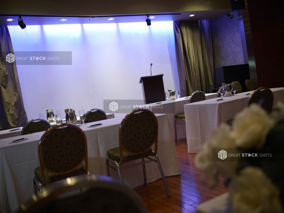 point of view perspective of an even space set up for a speaker with note pads and pens at the each seat