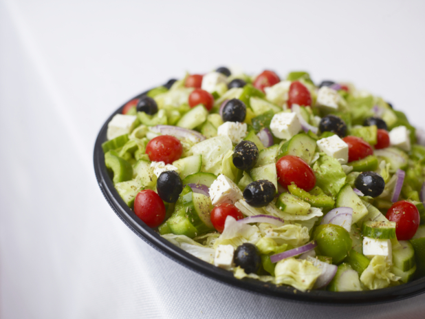 large catering greek salad with green peppers tomato black olives red onion dried oregano and feta cheese