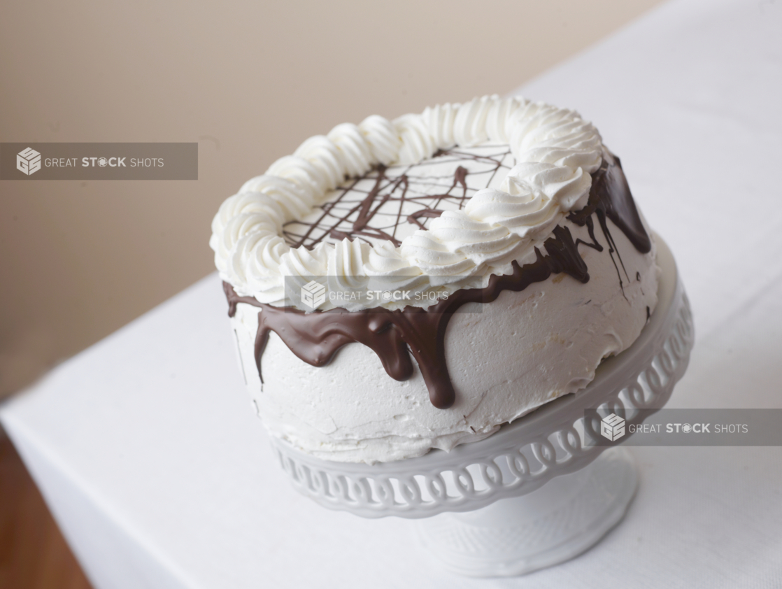 whole cake with white frosting chocolate ganache and whipped cream