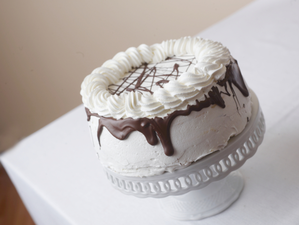 whole cake with white frosting chocolate ganache and whipped cream