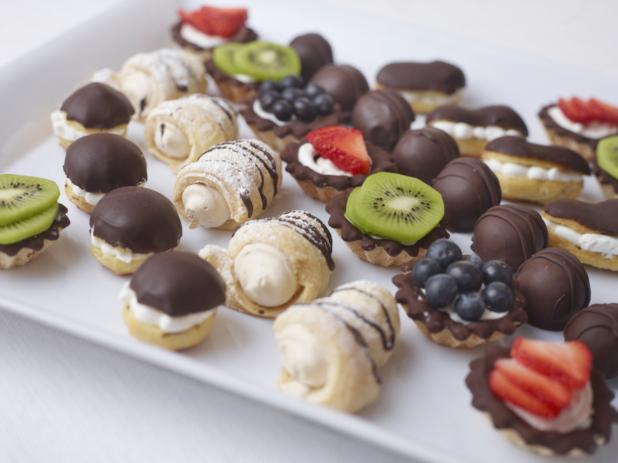 close up of assorted mini dessert tray on a white tray and white surface