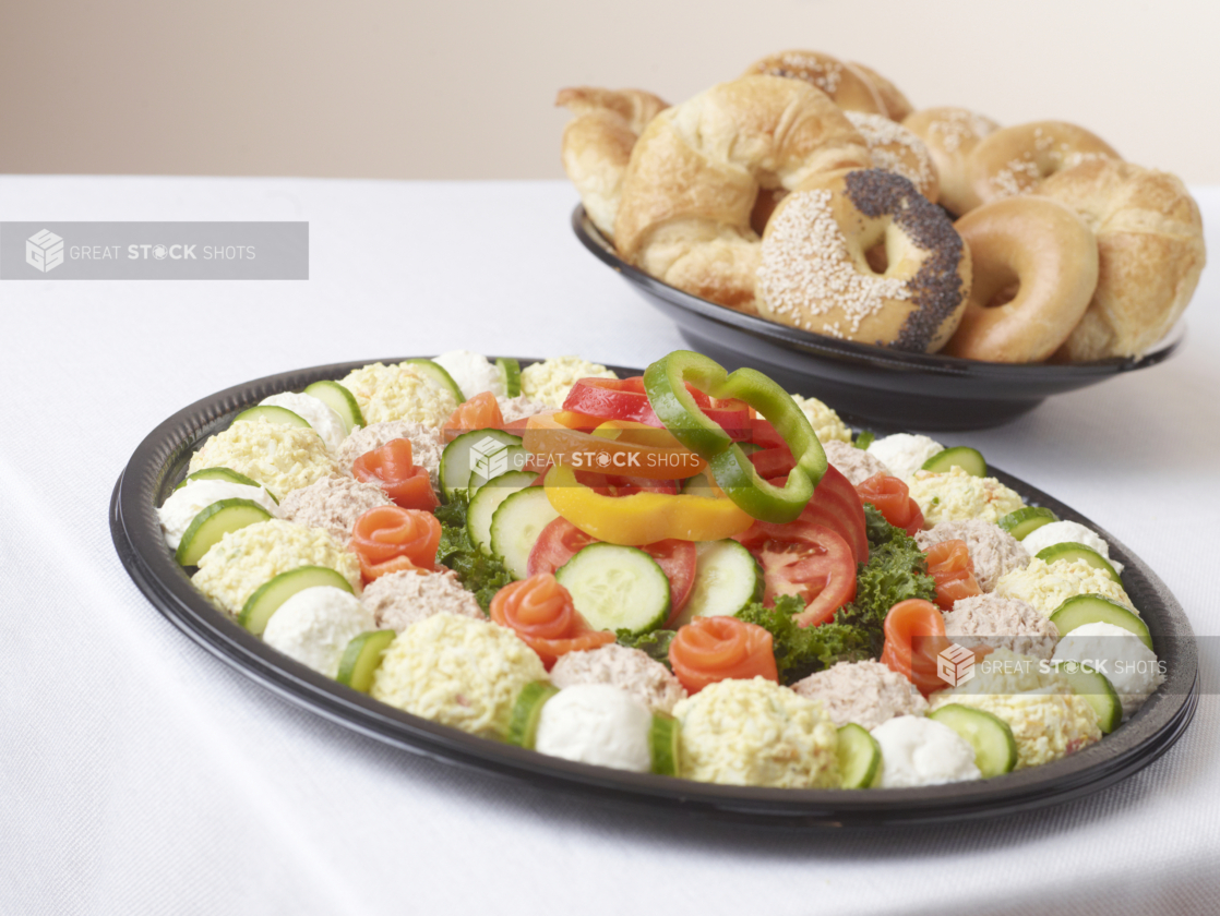 breakfast platter with smoked salmon rosettes tuna salad, egg salad, and cream cheese with a side of bagels