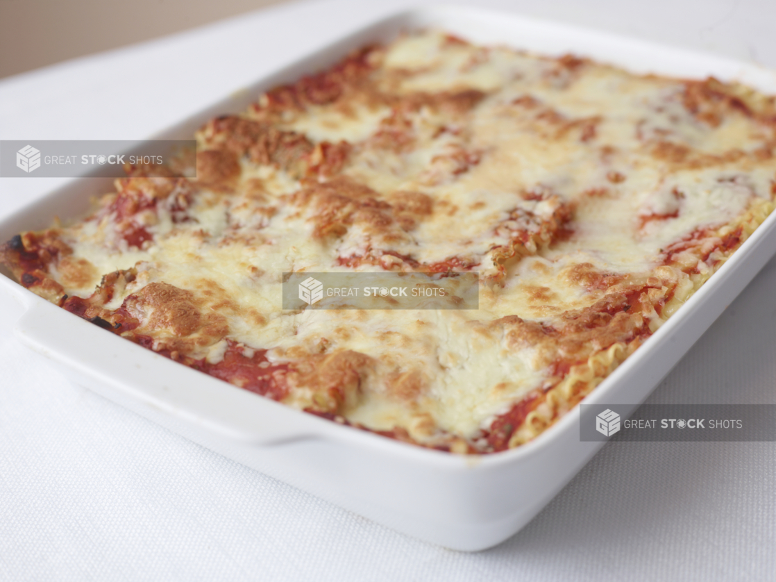 family size serving of lasagna on a white surface