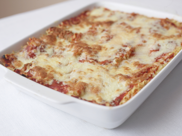 family size serving of lasagna on a white surface