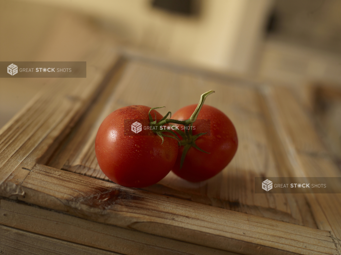 Cluster of two vine tomatoes on a rustic wood surface