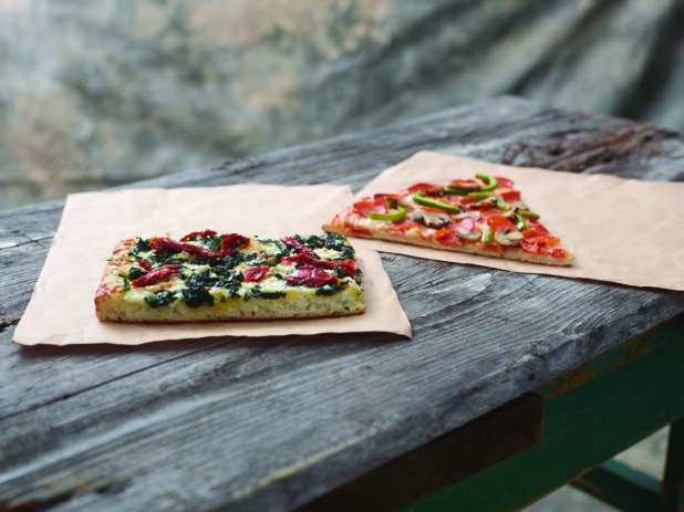 Jumbo Deluxe Pizza Slice and Romano Pizza al Taglio Slice on Kraft Paper on a Weathered Wooden Table - Variation