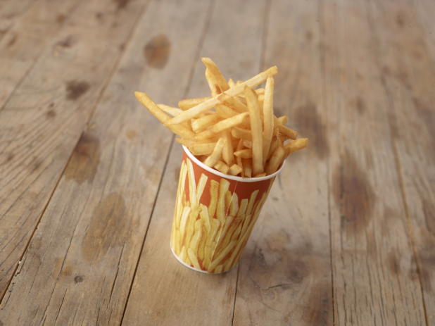 Cardboard Cup of Fresh, Thin-Cut French Fries on a Rustic Untreated Wood Surface