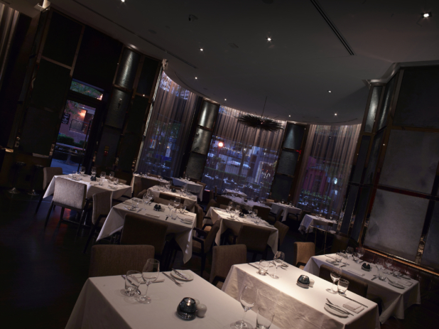 Classy Restaurant Interior with Dark, Moody Lighting, Formal Table Settings and a Semi-Circular Seating Area with Floor to Ceiling Windows