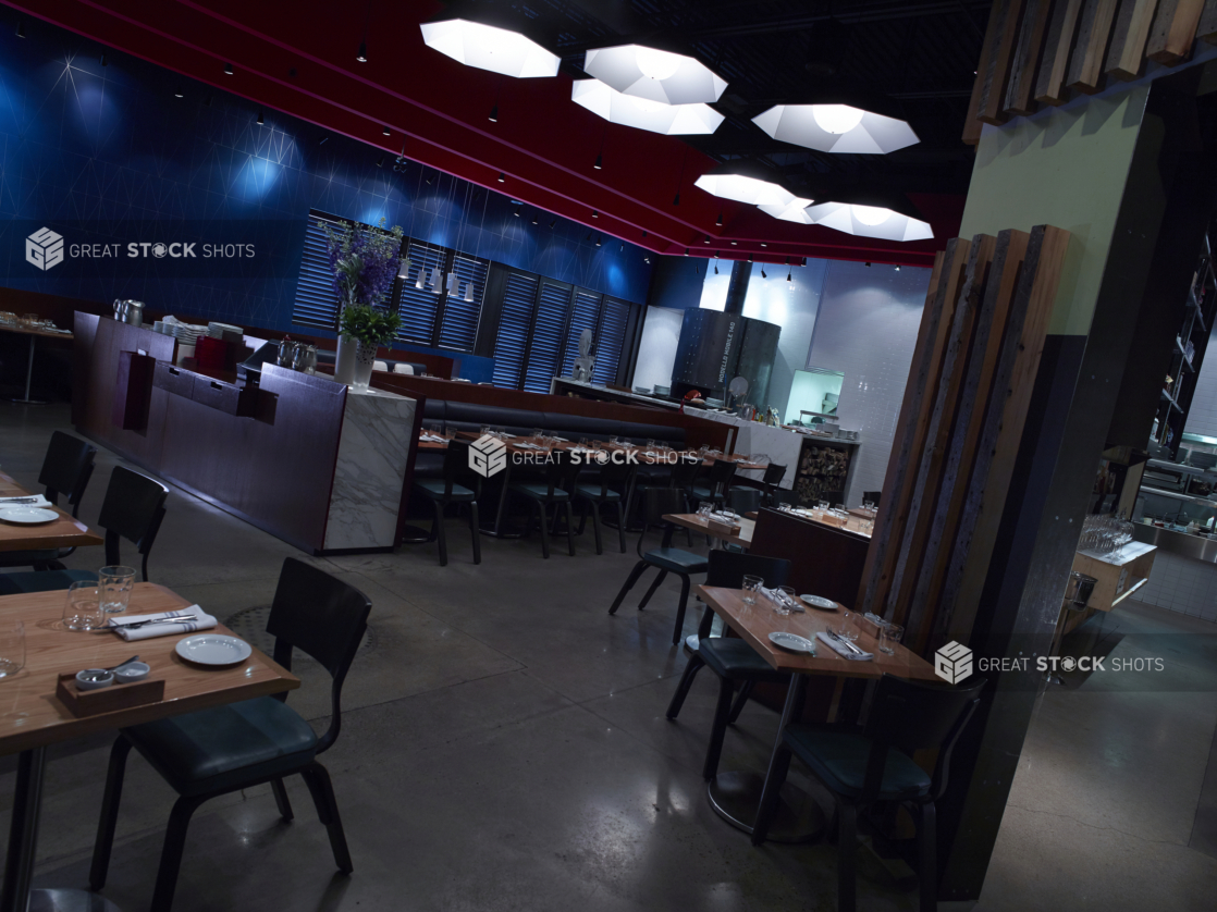 Interior of a Casual Restaurant Dining Area and Hostess Bar with Wood Panels, Blue Tiles, Marble Panelling and Moody Lighting