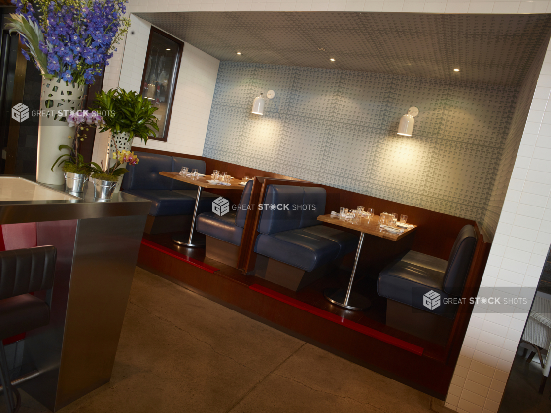 Elevated Booth Seating Area in a Casual Restaurant Setting with Floral Arrangements