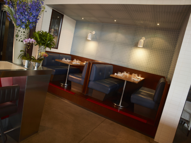 Elevated Booth Seating Area in a Casual Restaurant Setting with Floral Arrangements