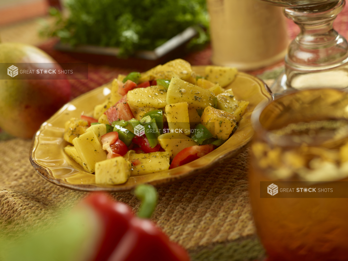 Mango and Bell Pepper Salad with Herbs and Olive Oil Dressing on a Placemat in an Indoor Setting