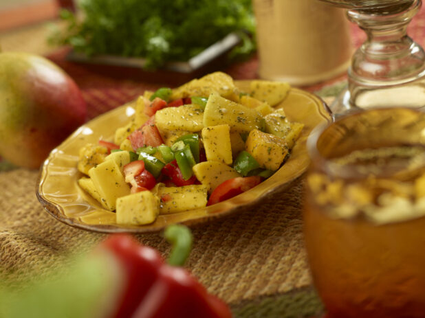 Mango and Bell Pepper Salad with Herbs and Olive Oil Dressing on a Placemat in an Indoor Setting