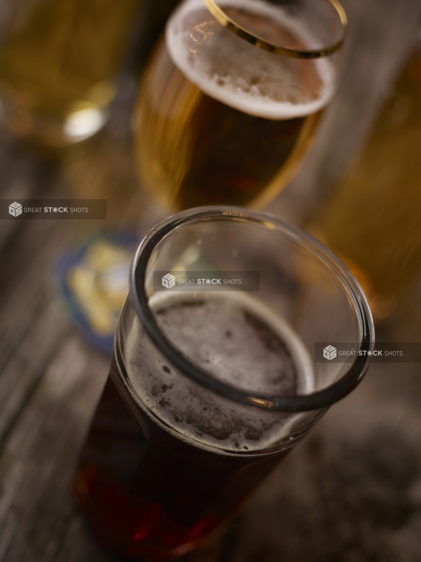 Assorted Glasses of Beer and Stout on an Aged Wooden Table Shot from a Slightly Elevated Angle