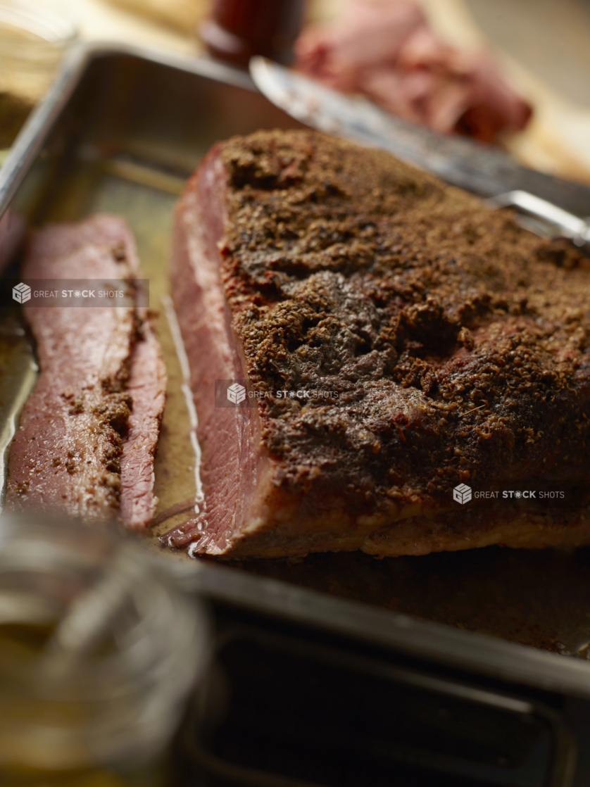 Close Up of a Roasting Pan with Beef Brisket Fresh Out of the Oven in a Kitchen Setting of a Restaurant