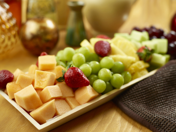 Cut fruit on a wooden catering tray