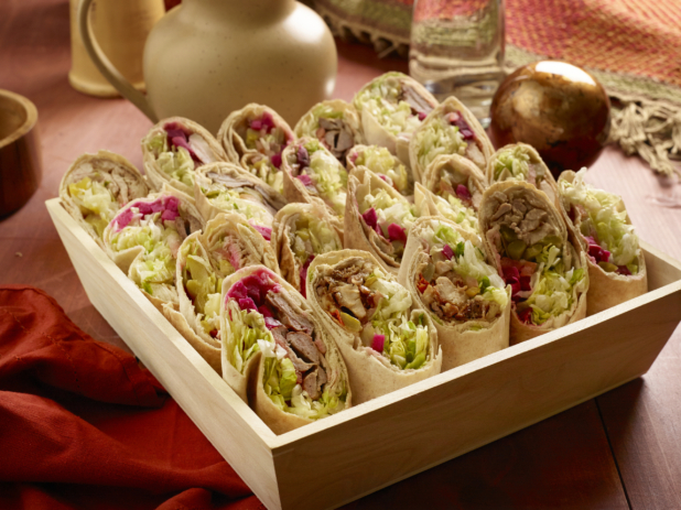 Assorted Middle Eastern Pita Wraps (Chicken and Beef Shawarma, Chicken and Beef Kebabs) in a Deep Square Wood Serving Tray for Catering on a Wooden Table in an Indoor Setting