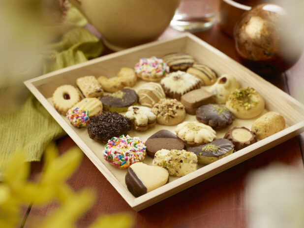 Small Lebanese Cookie Tray for Catering with Assorted Shortbread, Jam-Filled and Chocolate Covered Cookies on a Wooden Table in an Indoor Setting
